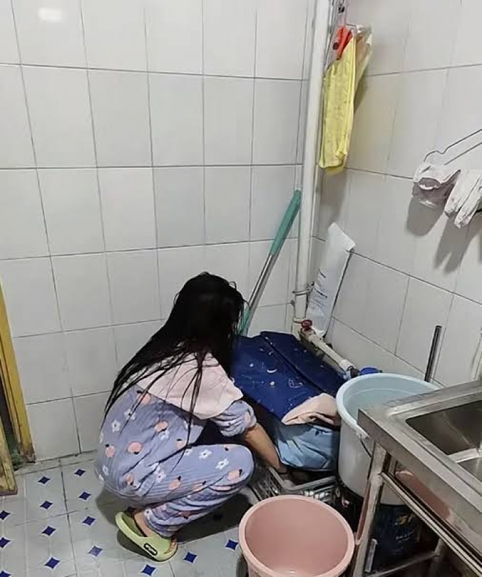 Woman lives in workplace toilet to save money on rent